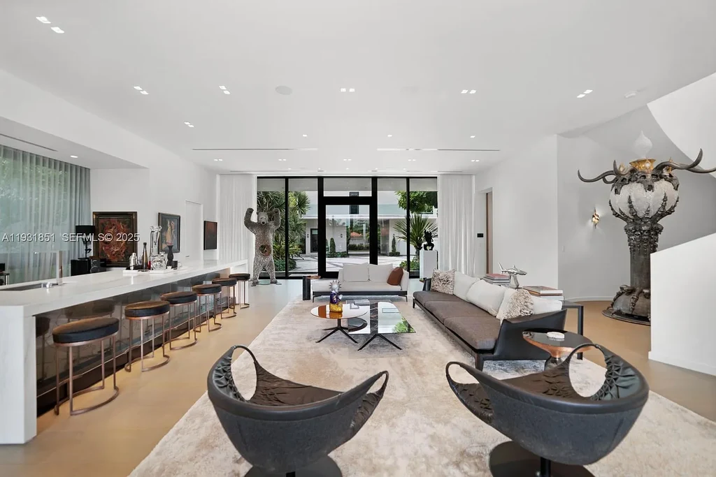 A $26 Million Tropical Modern Waterfront Estate Redefining Private Island Living in Miami Beach 6 Exterior of 6411 Allison Rd, a $26 million tropical modern home in Miami Beach with floor-to-ceiling glass