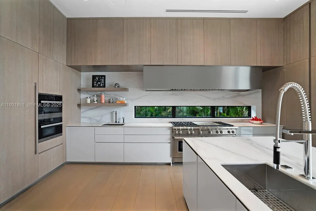 A $26 Million Tropical Modern Waterfront Estate Redefining Private Island Living in Miami Beach 8 Exterior of 6411 Allison Rd, a $26 million tropical modern home in Miami Beach with floor-to-ceiling glass