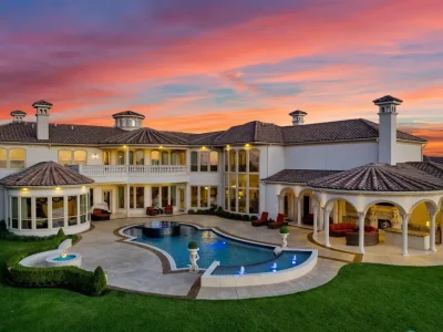 A Venetian Inspired Plano Estate Lists for 7.5 Million as a Rare Architectural Masterpiece in Kings Gate 1 Aerial view of the Venetian inspired estate at 6509 Sudbury Rd in Plano showcasing the resort pool multiple terraces arched loggias and Mediterranean roofline at sunset.