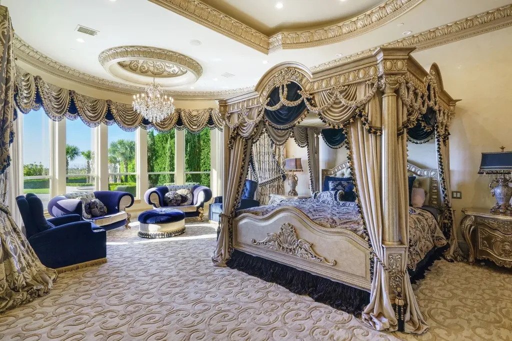 A Venetian Inspired Plano Estate Lists for 7.5 Million as a Rare Architectural Masterpiece in Kings Gate 7 Primary suite inside the Venetian inspired estate at 6509 Sudbury Rd in Plano featuring a grand canopy bed ornate drapery crystal chandelier and curved window wall.