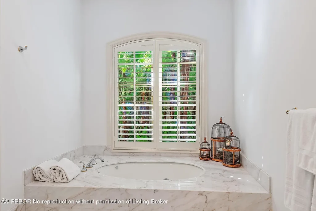 $35 Million Iconic Waterfront Estate on Everglades Island in Palm Beach 14 Waterfront exterior view of 751 Island Dr showcasing a luxury Palm Beach home for sale on Everglades Island