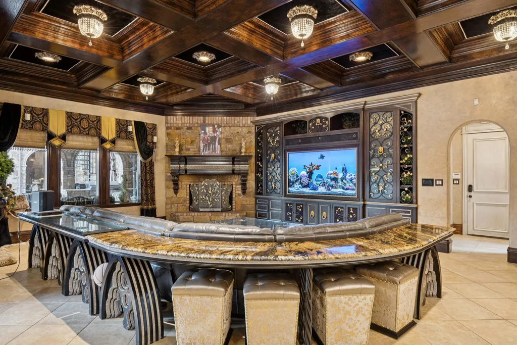 Castle Estate Heads to Auction at 6 Million as a Hilltop Masterpiece in Fort Worth 5 Formal living room inside the castle estate at 9553 Bella Terra Dr Fort Worth Texas featuring a grand stone fireplace curved staircase arched windows custom drapery and refined seating