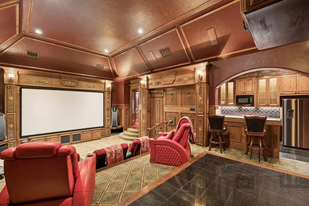 Castle Estate Heads to Auction at 6 Million as a Hilltop Masterpiece in Fort Worth 8 Private home theater at 9553 Bella Terra Dr Fort Worth Texas featuring luxury red leather seating custom wood paneling built in bar and large projection screen