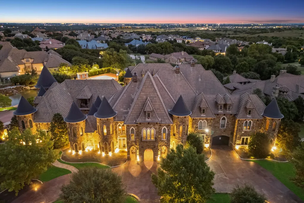 Castle Estate Heads to Auction at 6 Million as a Hilltop Masterpiece in Fort Worth 2 Aerial dusk view of the castle estate at 9553 Bella Terra Dr in Fort Worth Texas showcasing turrets stone architecture and hilltop setting in Montserrat