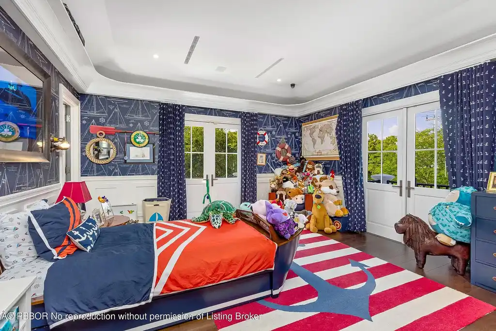 $26.9 Million North End Palm Beach Estate With Guest House and Resort-Style Grounds 14 Front exterior of 1053 N Lake Way, a luxury Palm Beach home for sale featuring Bermuda-style architecture and lush tropical landscaping.