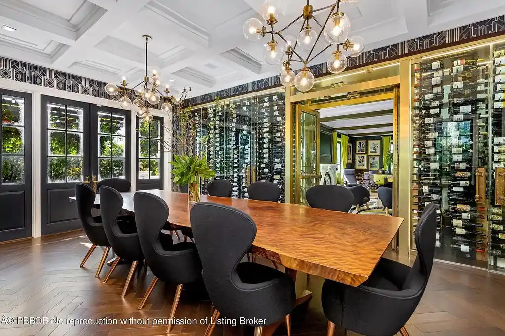 $26.9 Million North End Palm Beach Estate With Guest House and Resort-Style Grounds 11 Front exterior of 1053 N Lake Way, a luxury Palm Beach home for sale featuring Bermuda-style architecture and lush tropical landscaping.