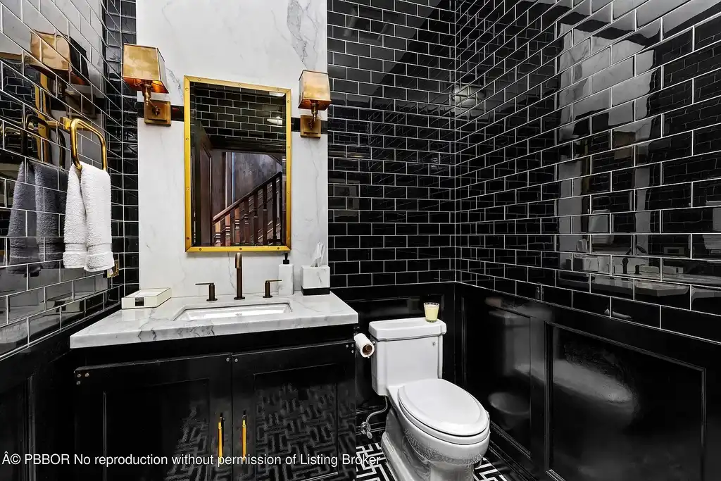 $26.9 Million North End Palm Beach Estate With Guest House and Resort-Style Grounds 15 Front exterior of 1053 N Lake Way, a luxury Palm Beach home for sale featuring Bermuda-style architecture and lush tropical landscaping.