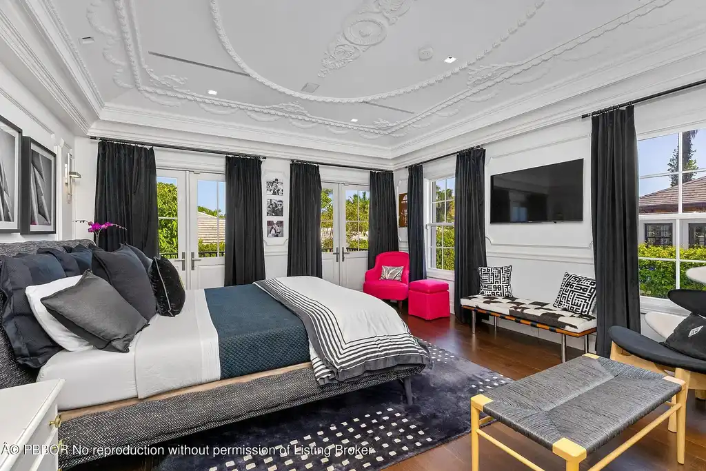 $26.9 Million North End Palm Beach Estate With Guest House and Resort-Style Grounds 12 Front exterior of 1053 N Lake Way, a luxury Palm Beach home for sale featuring Bermuda-style architecture and lush tropical landscaping.