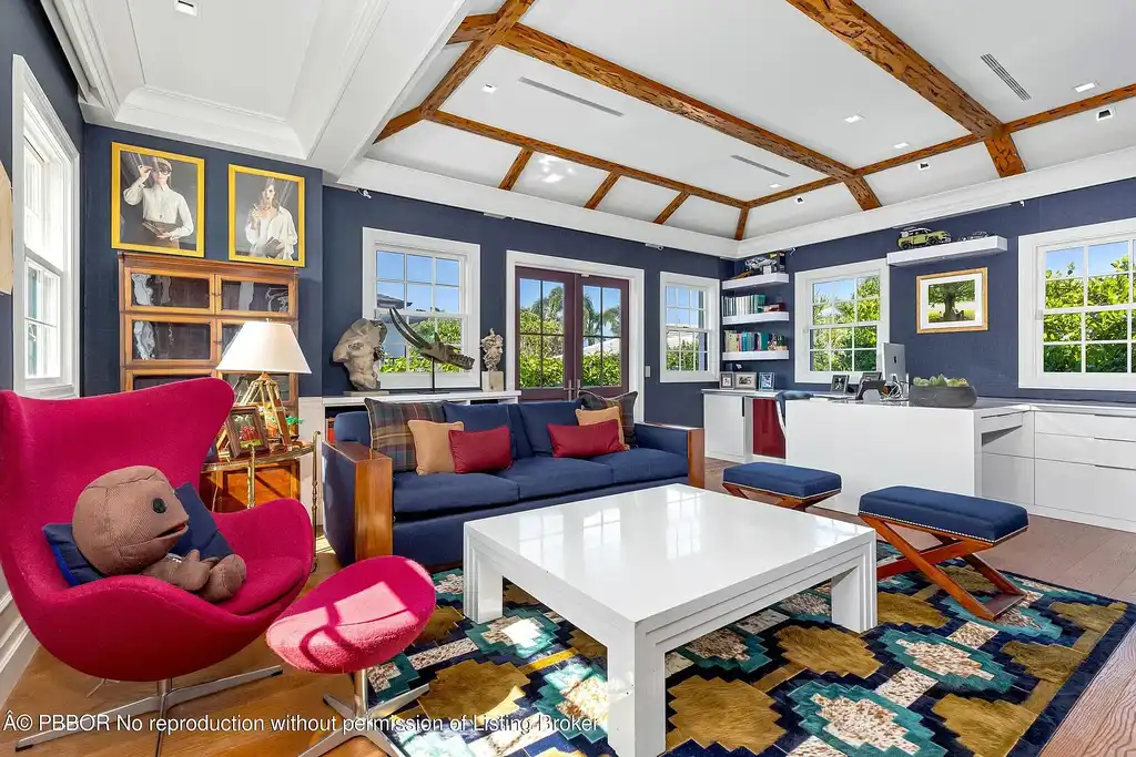 $26.9 Million North End Palm Beach Estate With Guest House and Resort-Style Grounds 6 Front exterior of 1053 N Lake Way, a luxury Palm Beach home for sale featuring Bermuda-style architecture and lush tropical landscaping.