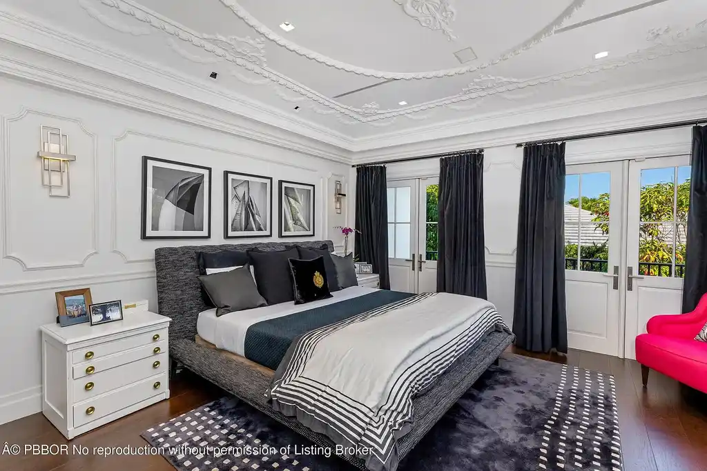 $26.9 Million North End Palm Beach Estate With Guest House and Resort-Style Grounds 13 Front exterior of 1053 N Lake Way, a luxury Palm Beach home for sale featuring Bermuda-style architecture and lush tropical landscaping.