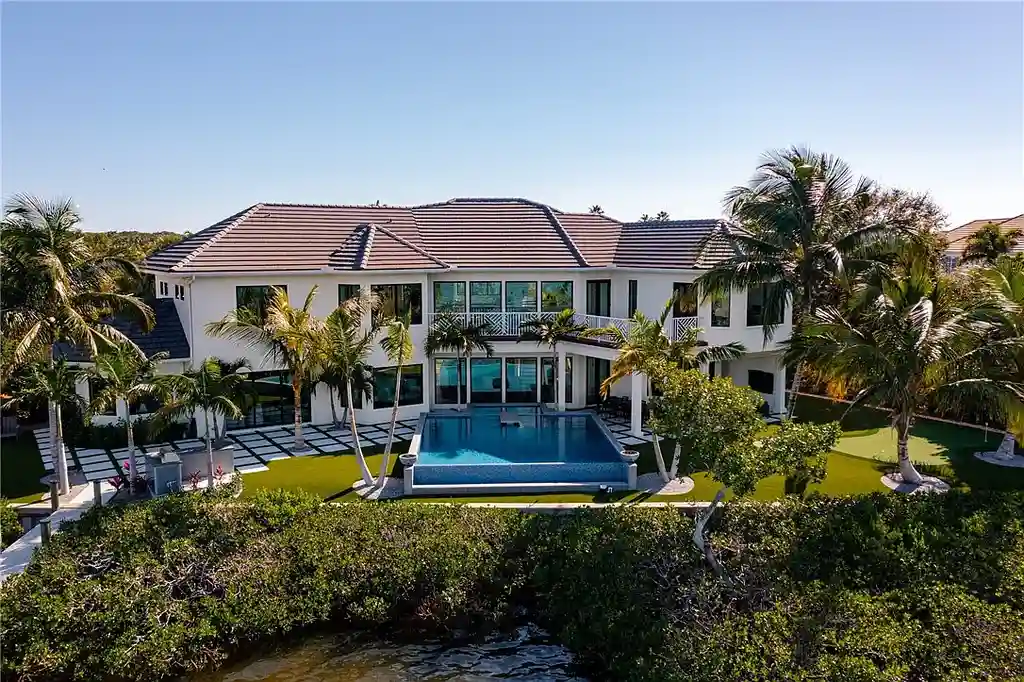 $6 Million Riverfront Estate in Vero Beach Offers Resort-Style Living and Rare Privacy 5 Riverfront exterior view of 225 Osprey Ct in Vero Beach showcasing tropical modern architecture and 175 feet of waterfront frontage