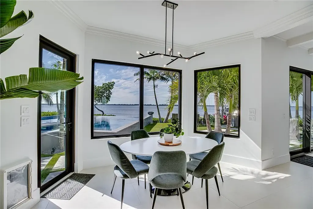 $6 Million Riverfront Estate in Vero Beach Offers Resort-Style Living and Rare Privacy 10 Riverfront exterior view of 225 Osprey Ct in Vero Beach showcasing tropical modern architecture and 175 feet of waterfront frontage