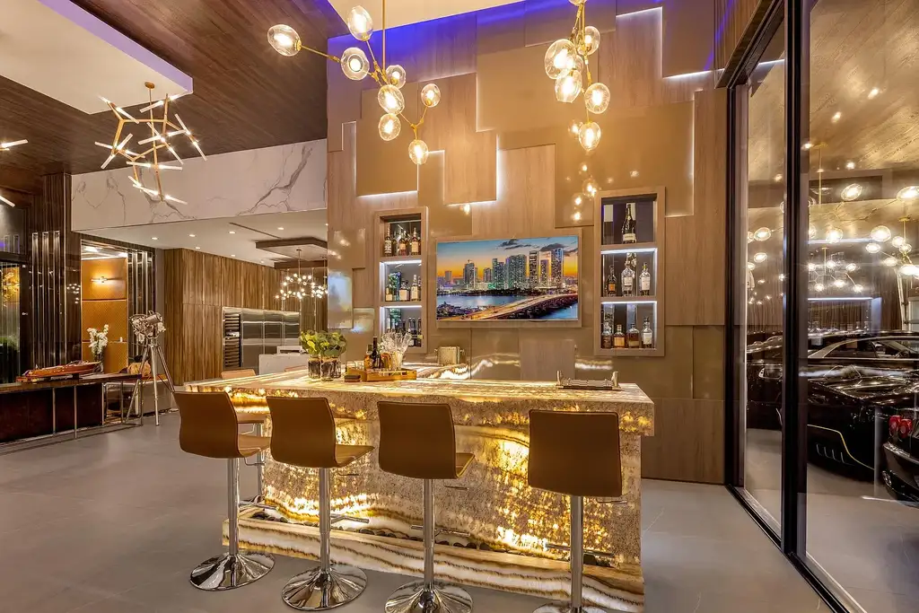 $10 Million Stunning Contemporary Estate Redefining Luxury Living in Fort Lauderdale 9 Modern kitchen at 2301 NE 37th Drive highlighting walnut cabinetry and refined stone surfaces