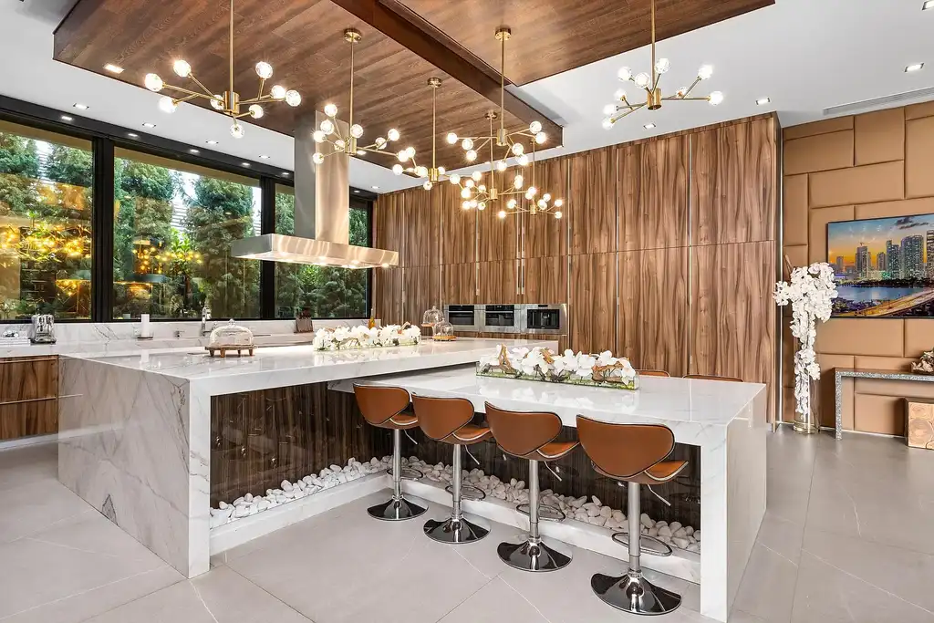 $10 Million Stunning Contemporary Estate Redefining Luxury Living in Fort Lauderdale 12 Modern kitchen at 2301 NE 37th Drive highlighting walnut cabinetry and refined stone surfaces