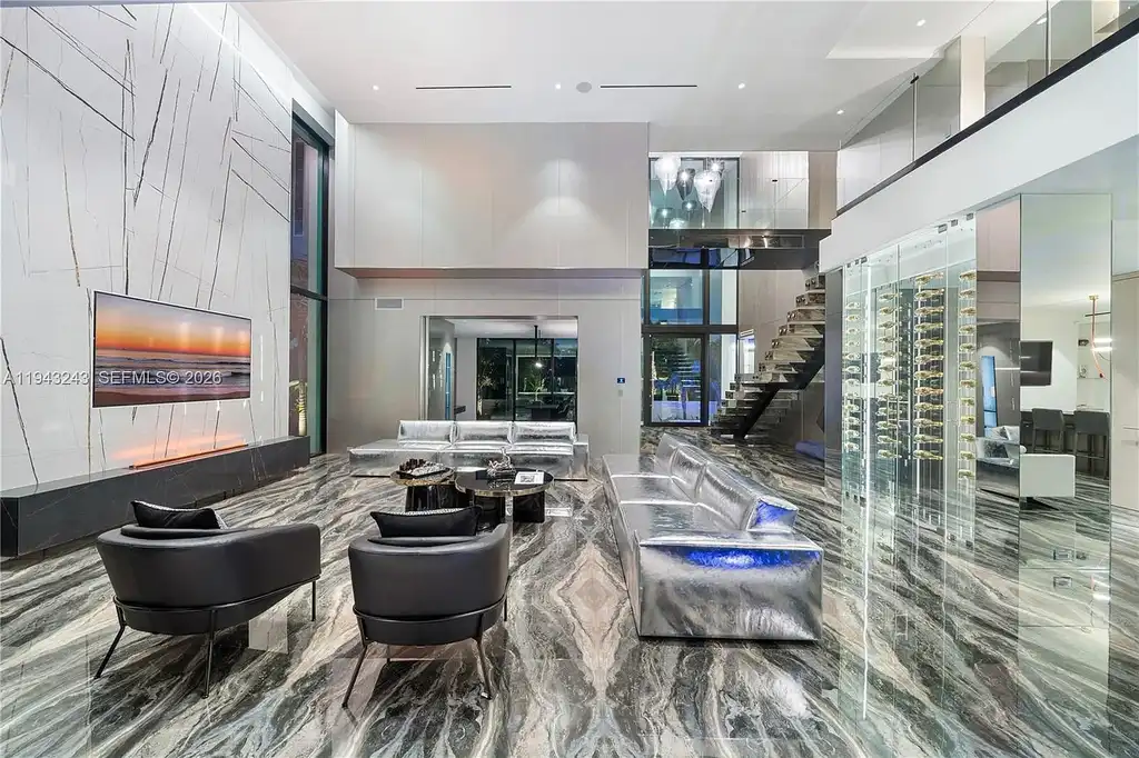 $14.4 Million Extraordinary Waterfront Estate Sets a New Standard for Luxury Living in Fort Lauderdale 8 Dining and lounge space at 340 San Marco Dr highlighting book-matched porcelain floors and refined modern interiors.