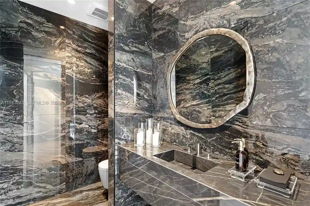 $14.4 Million Extraordinary Waterfront Estate Sets a New Standard for Luxury Living in Fort Lauderdale 14 Dining and lounge space at 340 San Marco Dr highlighting book-matched porcelain floors and refined modern interiors.