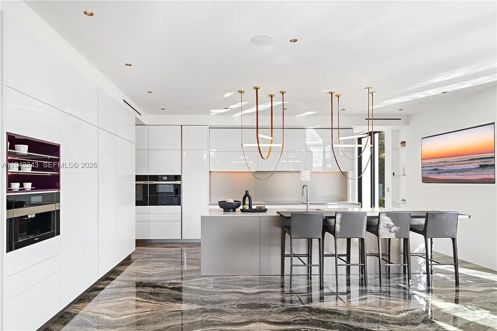$14.4 Million Extraordinary Waterfront Estate Sets a New Standard for Luxury Living in Fort Lauderdale 9 Dining and lounge space at 340 San Marco Dr highlighting book-matched porcelain floors and refined modern interiors.
