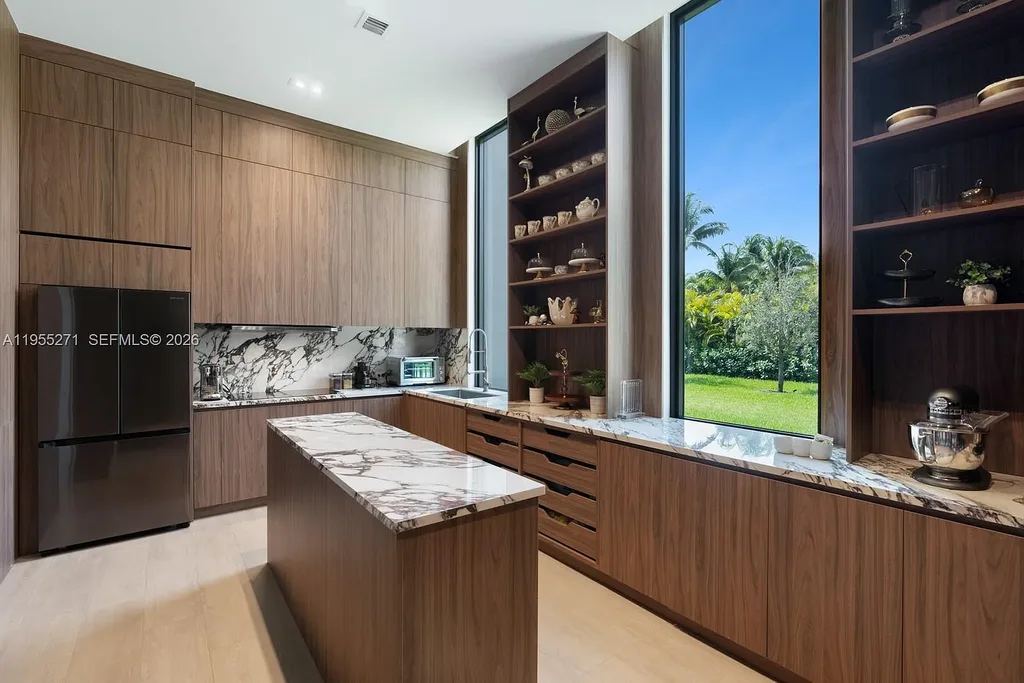 $16.7 Million Newly Built Estate Sets a New Benchmark for Luxury Living in Pinecrest 9 Front exterior of a newly built luxury home at 5900 SW 129th Ter in Pinecrest, Florida, showcasing modern architecture and landscaped grounds