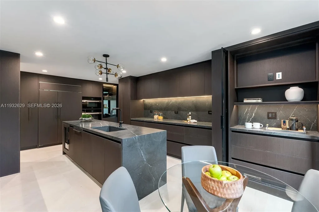 $15.8 Million Trophy Waterfront Estate Redefining Luxury Living in Coral Gables 10 Waterfront exterior of 6970 Sunrise Dr showcasing a contemporary estate with canal frontage and direct access to Biscayne Bay in Coral Gables