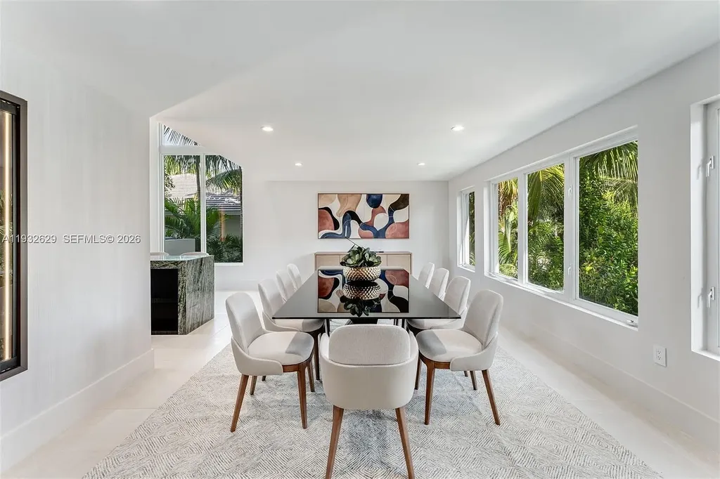 $15.8 Million Trophy Waterfront Estate Redefining Luxury Living in Coral Gables 11 Waterfront exterior of 6970 Sunrise Dr showcasing a contemporary estate with canal frontage and direct access to Biscayne Bay in Coral Gables