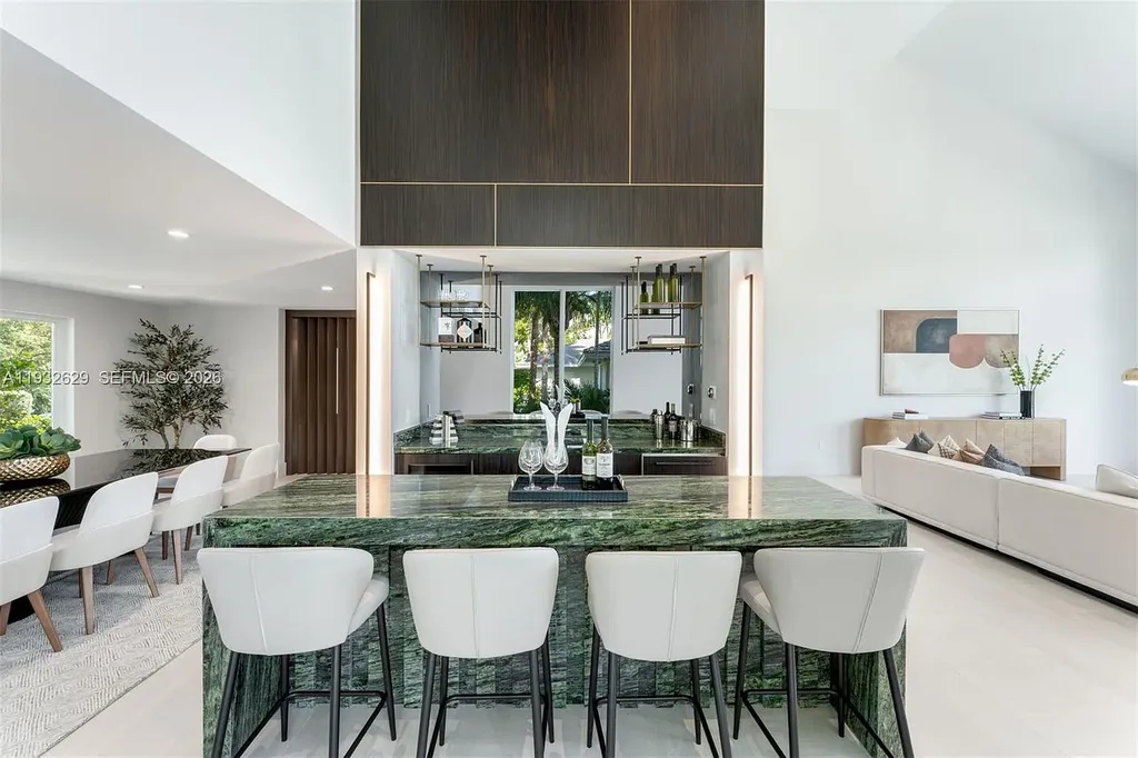 $15.8 Million Trophy Waterfront Estate Redefining Luxury Living in Coral Gables 9 Waterfront exterior of 6970 Sunrise Dr showcasing a contemporary estate with canal frontage and direct access to Biscayne Bay in Coral Gables