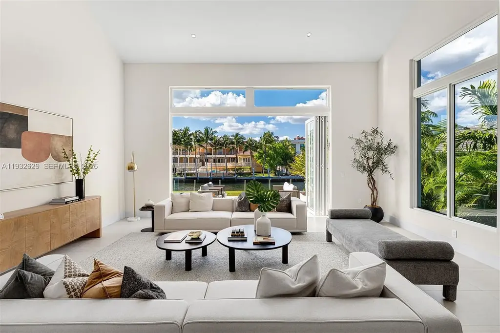 $15.8 Million Trophy Waterfront Estate Redefining Luxury Living in Coral Gables 7 Waterfront exterior of 6970 Sunrise Dr showcasing a contemporary estate with canal frontage and direct access to Biscayne Bay in Coral Gables