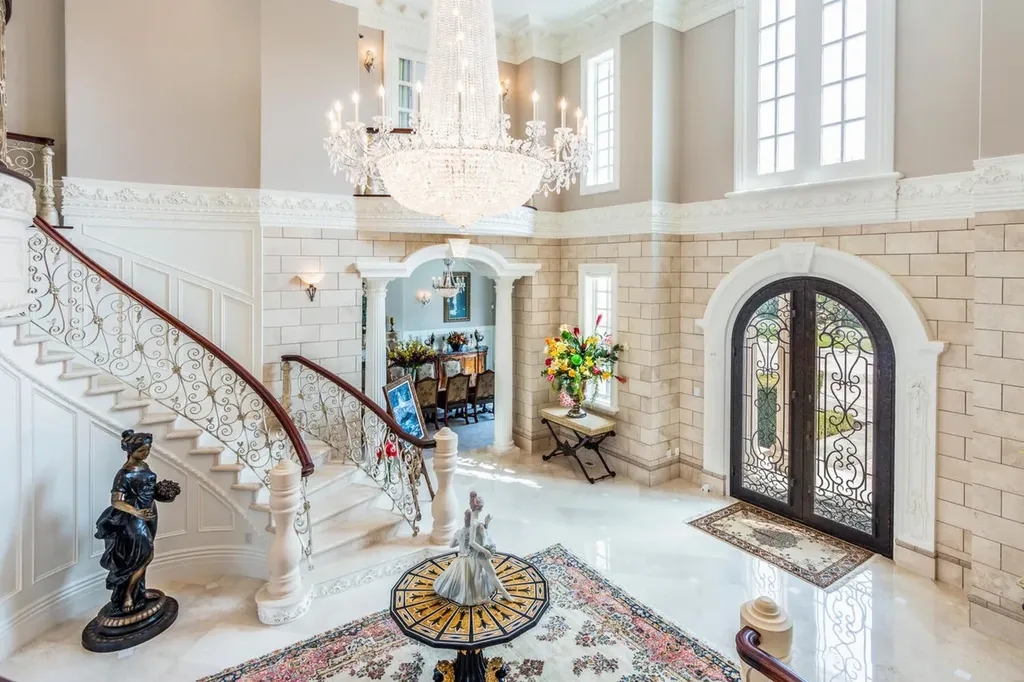 Hobble Creek Ranch: A 3,387-Acre Legacy Estate in Springville, Utah, Asking $38 Million 4 Grand double-height foyer at Hobble Creek Ranch featuring a sweeping curved staircase, crystal chandelier, and ornate iron entry doors in Springville, Utah.