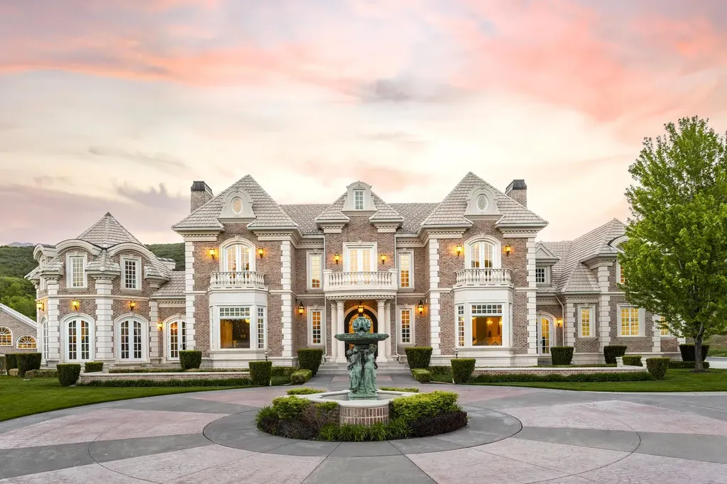 Hobble Creek Ranch: A 3,387-Acre Legacy Estate in Springville, Utah, Asking $38 Million 3 Front elevation of Hobble Creek Ranch mansion at dusk with symmetrical stone façade, arched windows, and a central fountain in Springville, Utah.