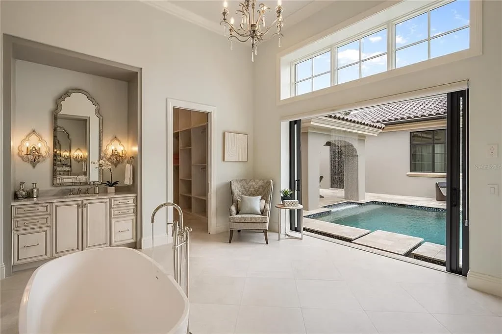 $10.5Million Spectacular Reimagined Luxury Estate in Golden Oak, Orlando 13 Front exterior view of 10012 Hyperion Ln luxury home in Orlando with arched entry and manicured landscaping