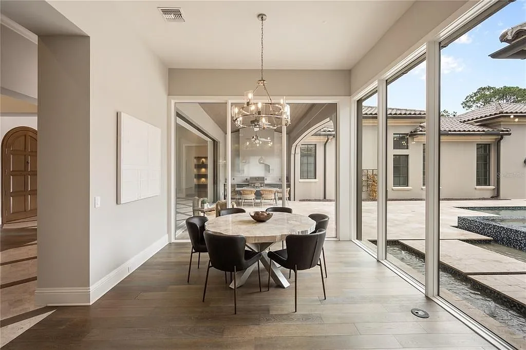 $10.5Million Spectacular Reimagined Luxury Estate in Golden Oak, Orlando 9 Front exterior view of 10012 Hyperion Ln luxury home in Orlando with arched entry and manicured landscaping