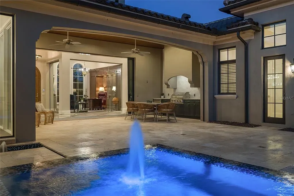 $10.5Million Spectacular Reimagined Luxury Estate in Golden Oak, Orlando 17 Front exterior view of 10012 Hyperion Ln luxury home in Orlando with arched entry and manicured landscaping