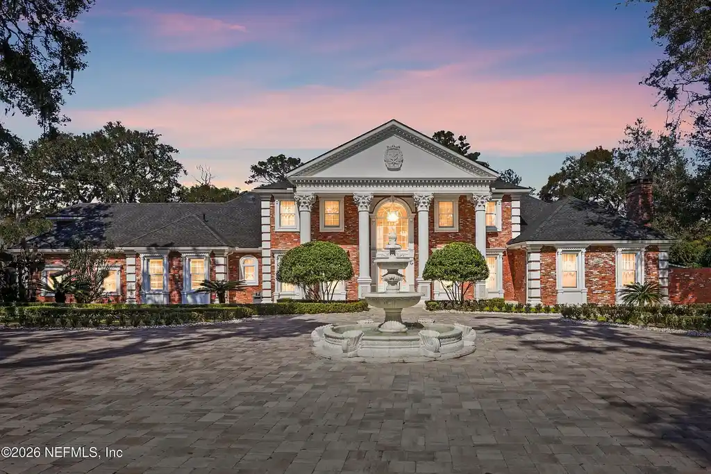 Stunning $7 Million Private Waterfront Estate in Jacksonville Redefines Luxury Living with Nearly Five Acres 5 Front exterior view of luxury waterfront estate in Jacksonville featuring grand neoclassical architecture, private acreage, and resort-style pool at 1370 MOSS CREEK Drive.