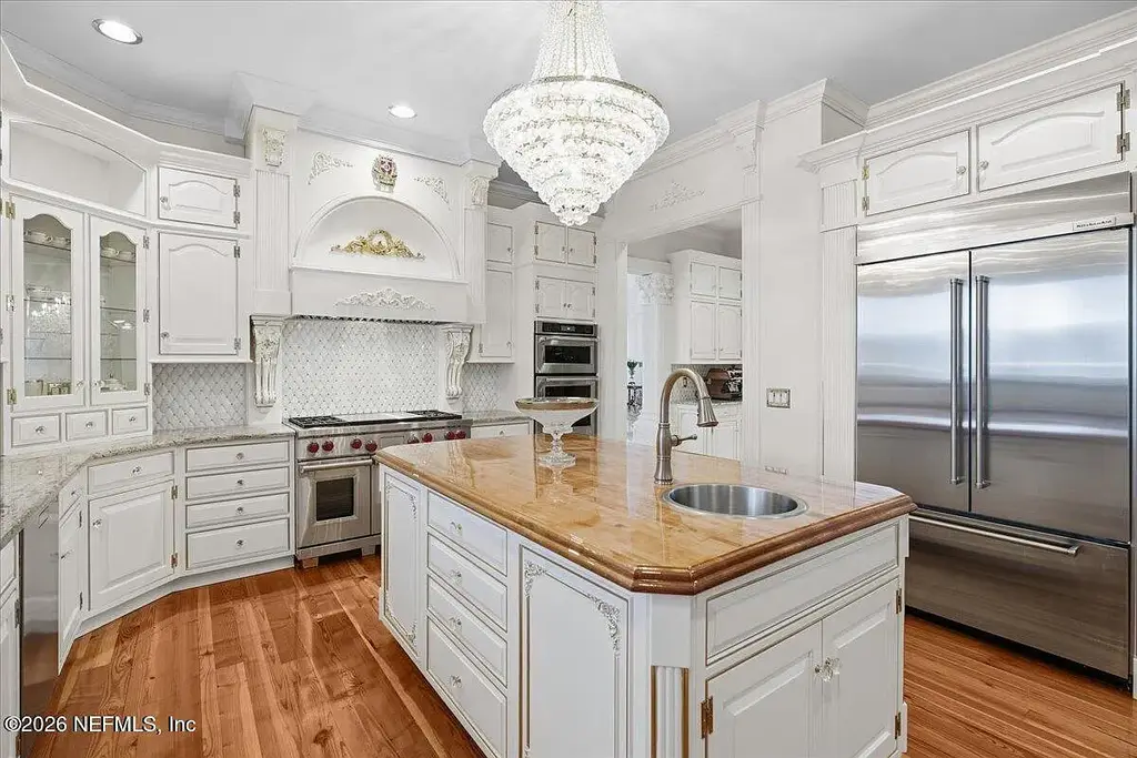 Stunning $7 Million Private Waterfront Estate in Jacksonville Redefines Luxury Living with Nearly Five Acres 8 Front exterior view of luxury waterfront estate in Jacksonville featuring grand neoclassical architecture, private acreage, and resort-style pool at 1370 MOSS CREEK Drive.