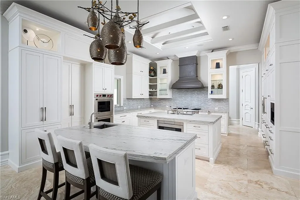 A Fully Reimagined Grey Oaks Estate in Naples Lists for $10 Million With Water and Fairway Views 9 State-of-the-art kitchen with dual islands and Wolf appliances inside 2145 Canna Way in Naples