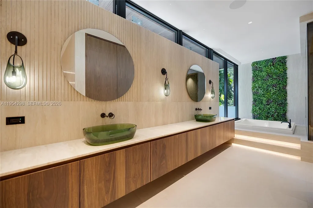 Spectacular $18 Million Ultra-Luxury New Construction Estate in Miami Showcases Iconic Modern Design 13 Modern ultra-luxury estate at 3210 Coacoochee St in Miami featuring contemporary architecture, expansive glass walls, private terraces, resort-style pool and spa, and landscaped tropical outdoor living areas.