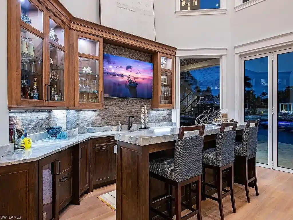 $17.9 Million Turnkey Waterfront Estate Offers Exceptional Living in Port Royal, Naples 15 Front exterior view of 3243 Gin LN, a $17.9 million waterfront estate in Port Royal, Naples