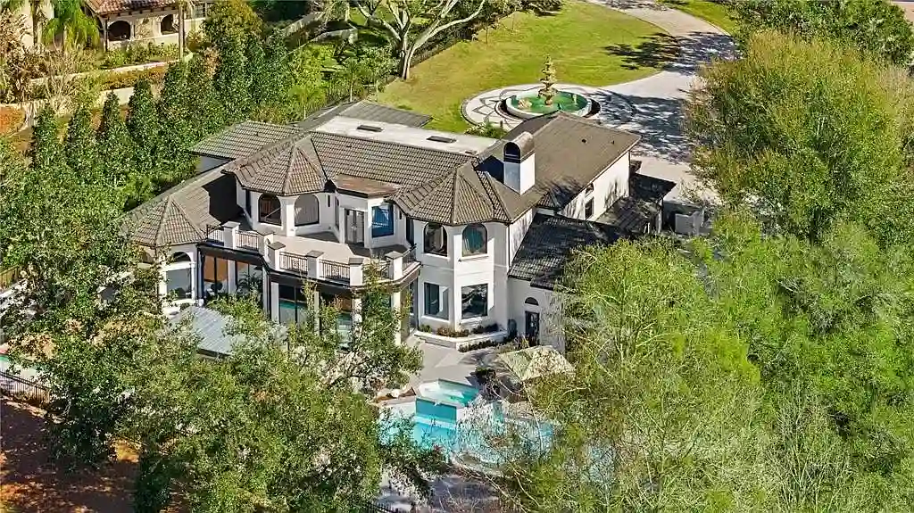 $5.7 Million Newly Remodeled Isleworth Golf Estate Showcases Spectacular Resort-Style Luxury in Windermere 17 Aerial view of 5186 Vardon Dr luxury estate showcasing golf course frontage and resort-style outdoor amenities