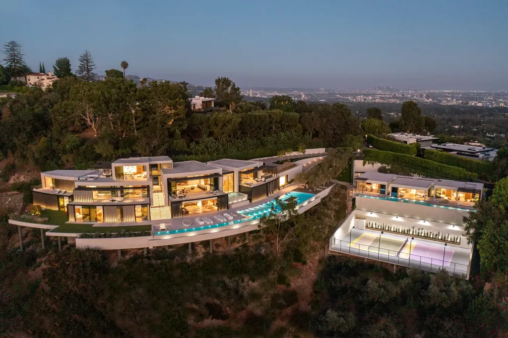 La Vue Mansion Commands $177 Million as a Singular Contemporary Icon in Bel Air 1 Aerial view of La Vue Mansion in Bel Air showcasing a contemporary hillside estate with infinity pool tennis court and sweeping views across Los Angeles at dusk.