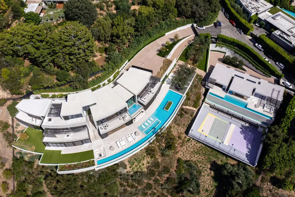La Vue Mansion Commands $177 Million as a Singular Contemporary Icon in Bel Air 3 Top down aerial view of La Vue Mansion in Bel Air showing the contemporary main residence infinity pool terraces and private tennis court set into the hillside.