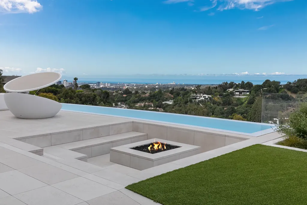La Vue Mansion Commands $177 Million as a Singular Contemporary Icon in Bel Air 4 Infinity edge pool and sunken fire pit terrace at La Vue Mansion in Bel Air overlooking sweeping city and ocean views across Los Angeles.
