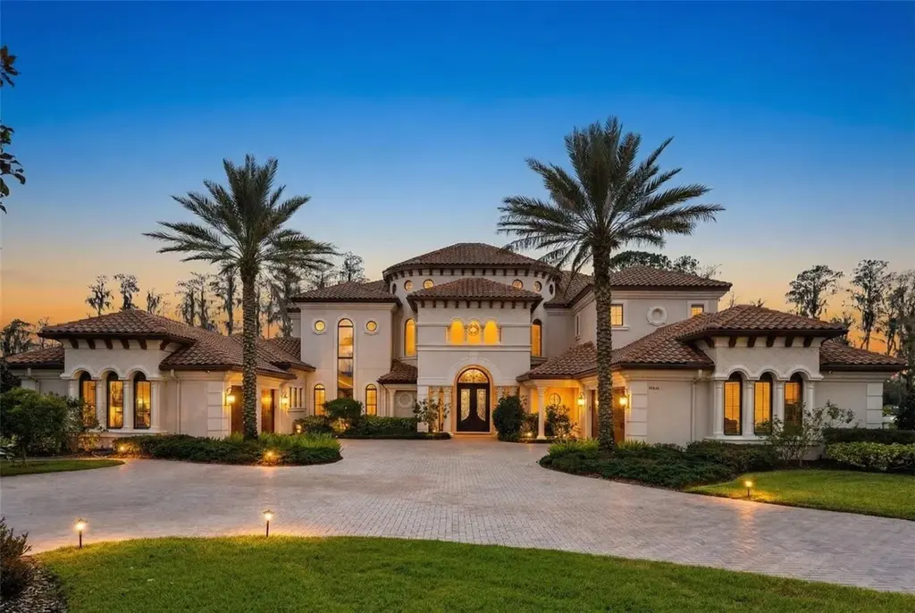 $6 Million Lakefront Mediterranean Estate Elevates Luxury Living in Odessa with Nearly Six Private Acres 17 Front elevation of 17124 Crawley Rd showcasing gated entrance and expansive estate grounds in Odessa Real Estate