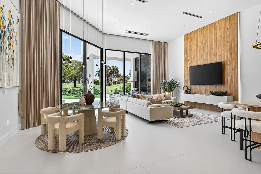 A $12.5 Million Contemporary Estate Redefines Luxury Living in Boca Raton’s Prestigious St Andrews Country Club 7 Modern luxury home at 17699 Lake Estates Drive in Boca Raton featuring a resort-style pool, expansive glass architecture, and contemporary design in St Andrews Country Club