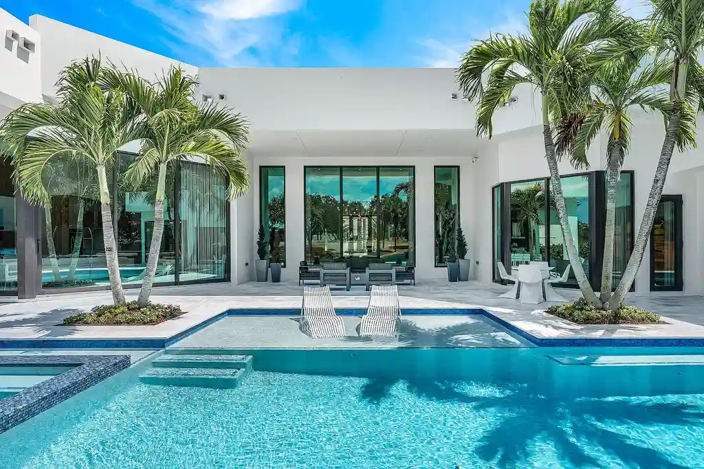 A $12.5 Million Contemporary Estate Redefines Luxury Living in Boca Raton’s Prestigious St Andrews Country Club 6 Modern luxury home at 17699 Lake Estates Drive in Boca Raton featuring a resort-style pool, expansive glass architecture, and contemporary design in St Andrews Country Club