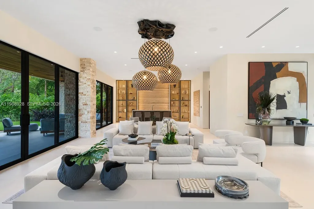 A $22 Million Tropical Modern Estate Brings Resort-Style Living to Miami’s Prestigious Ponce Davis 8 Luxury tropical modern estate in Miami with private tennis court, pool, and expansive outdoor living spaces at sunset