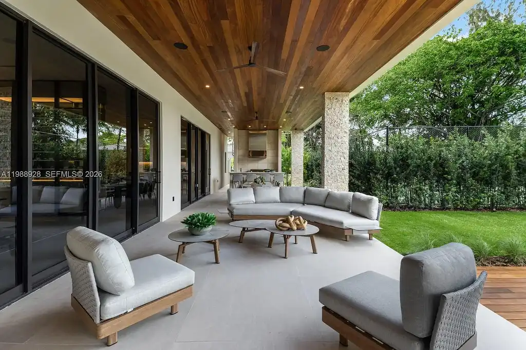 A $22 Million Tropical Modern Estate Brings Resort-Style Living to Miami’s Prestigious Ponce Davis 6 Luxury tropical modern estate in Miami with private tennis court, pool, and expansive outdoor living spaces at sunset