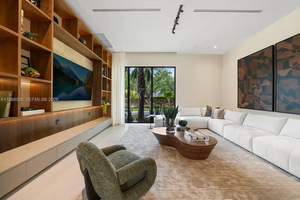 A $22 Million Tropical Modern Estate Brings Resort-Style Living to Miami’s Prestigious Ponce Davis 9 Luxury tropical modern estate in Miami with private tennis court, pool, and expansive outdoor living spaces at sunset