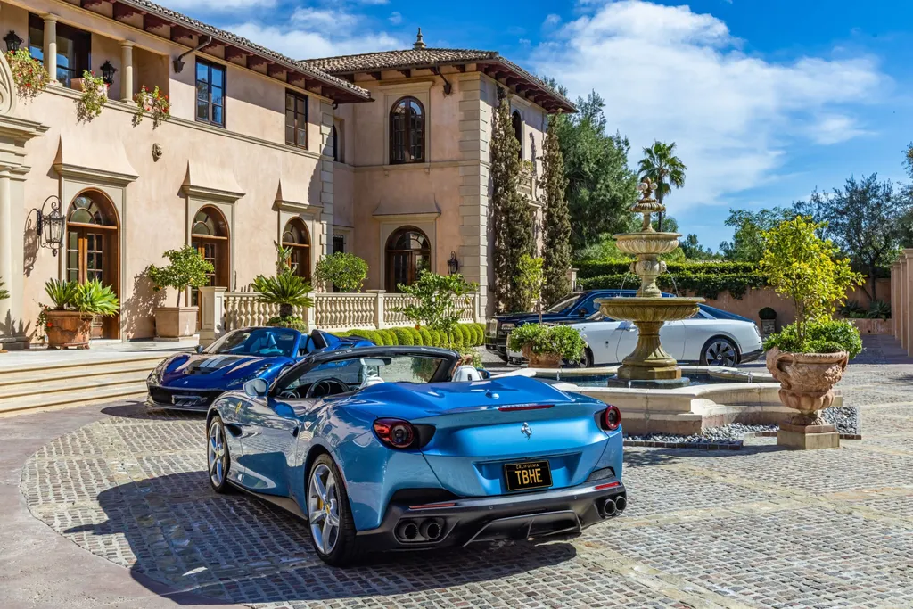 A $68,000,000 Beverly Park Estate Signals a New Era of Ultra-Scale Luxury in Los Angeles 3 Luxury cars parked in the driveway of a Beverly Park estate in Los Angeles with Mediterranean-style architecture and landscaped courtyard