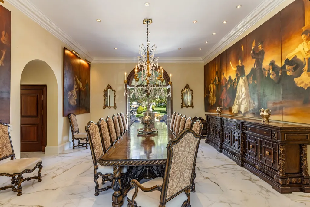A $68,000,000 Beverly Park Estate Signals a New Era of Ultra-Scale Luxury in Los Angeles 7 Formal dining room inside a Beverly Park estate in Los Angeles featuring a long wooden table, chandelier lighting, classic artwork, and luxury interior design