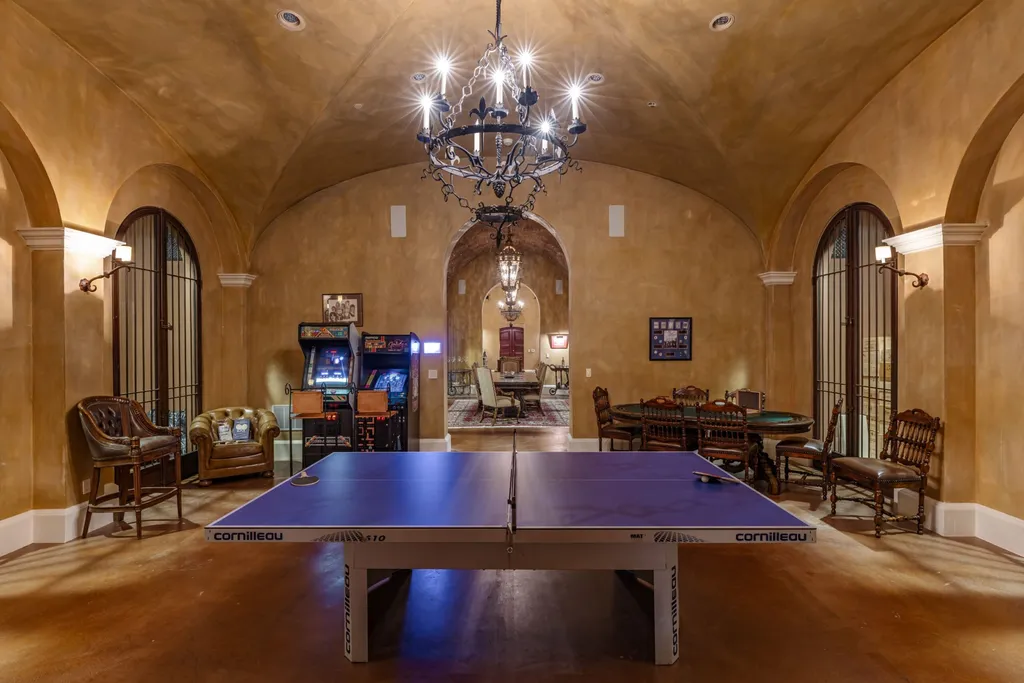 A $68,000,000 Beverly Park Estate Signals a New Era of Ultra-Scale Luxury in Los Angeles 11 Luxury game room inside a Beverly Park estate in Los Angeles featuring a ping pong table, arcade machines, and entertainment space design