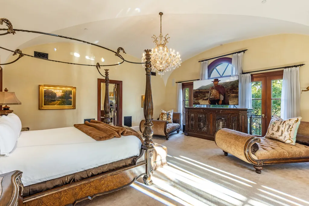 A $68,000,000 Beverly Park Estate Signals a New Era of Ultra-Scale Luxury in Los Angeles 8 Luxury master bedroom inside a Beverly Park estate in Los Angeles featuring classic furnishings, chandelier lighting, and large windows with natural light